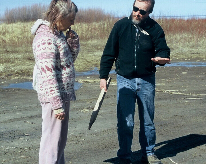 Lorne Fitch onsite speaking with a female landowner in front of prairie grass and shrubs.