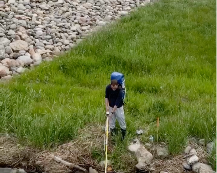 Man using qPCR backpack to sample for organisms.