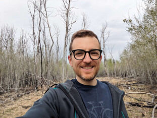 Quinn Barber stands in front of a former fire site in the Edmonton area. Photo provided.