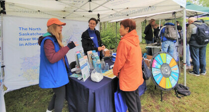Staff discussing the Watershed with the public at an outdoor event.